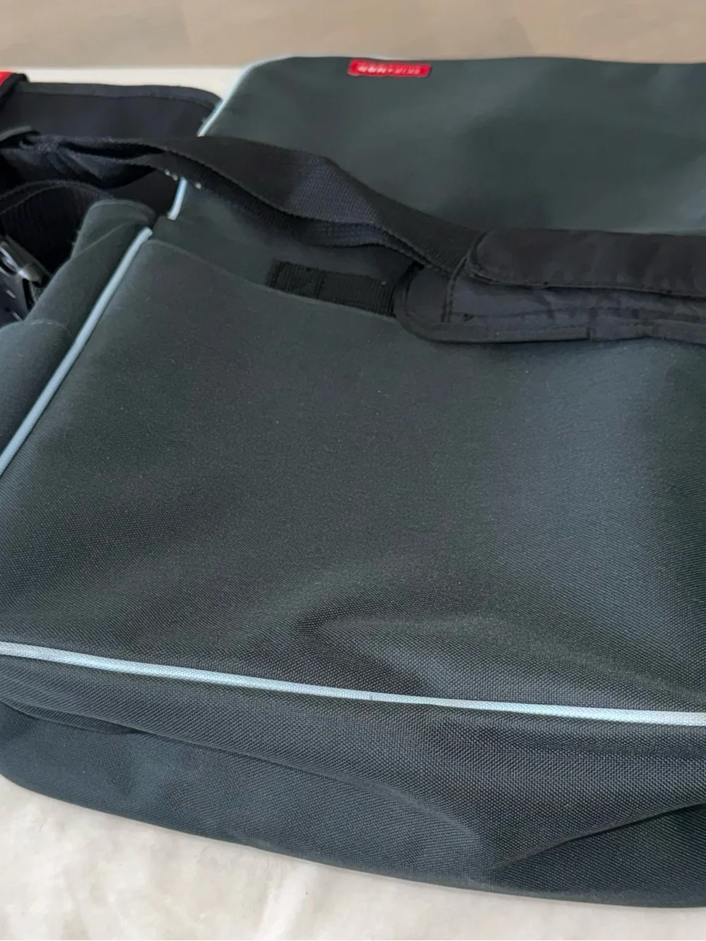 Skip Hop Black Messenger Bag with Light Blue Piping
